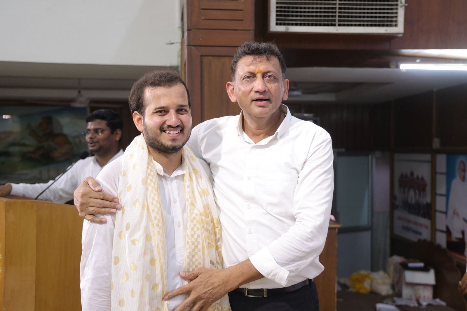 A scholar felicitating a participant