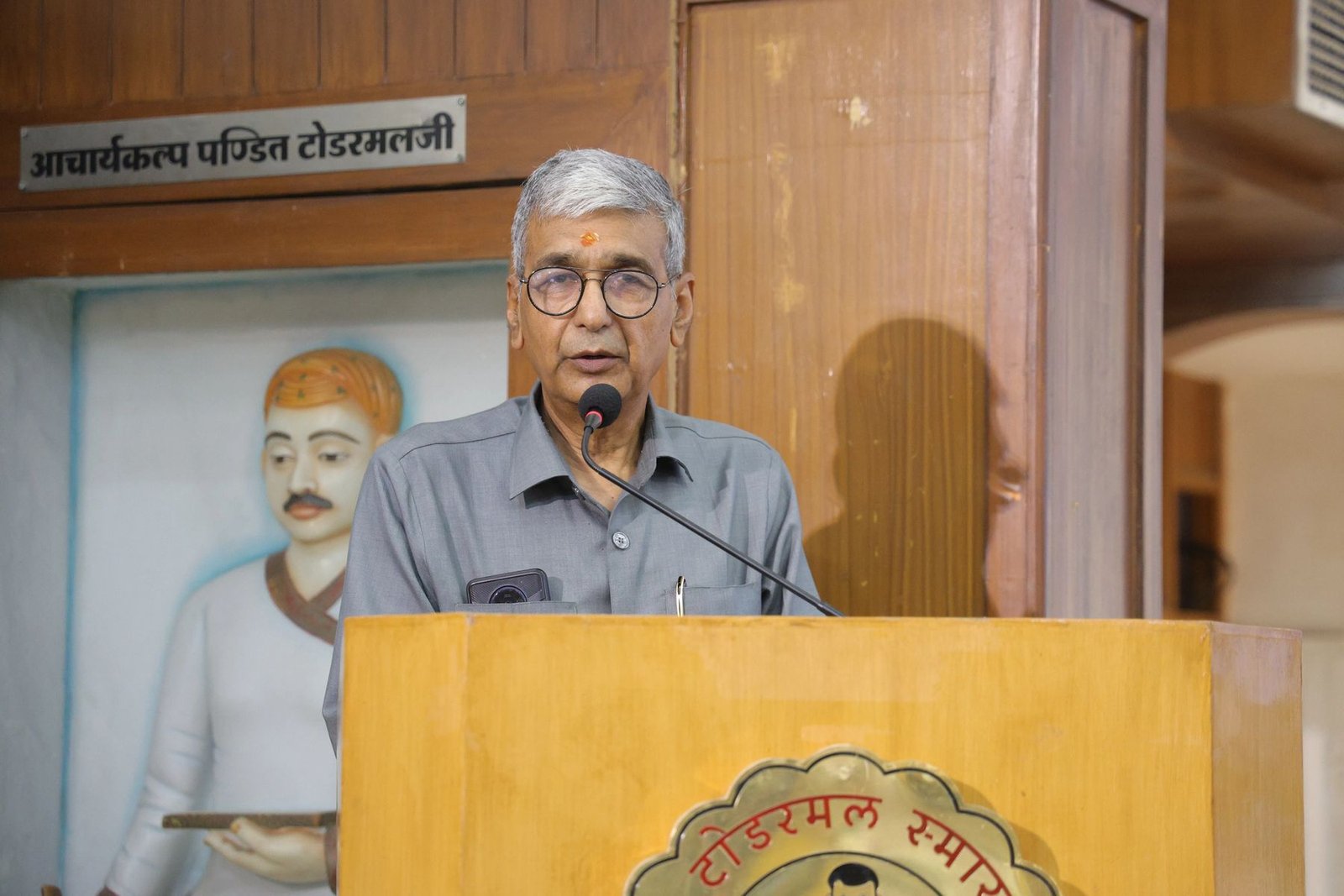 A senior scholar addressing participants